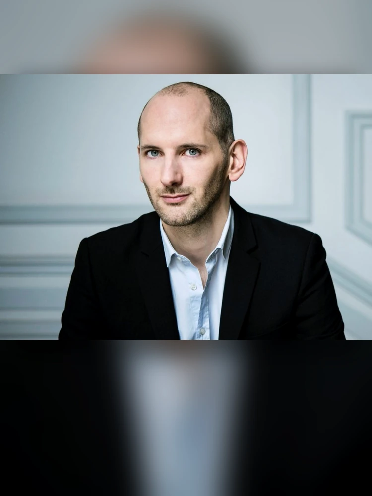 Quentin Bisch, perfumer of Amouage Guidance, shown with his complete head and upper body